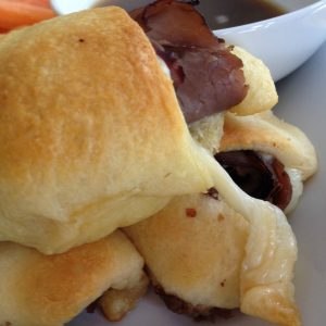 French Dip Crescents with easy Au Jus -- Easy, peasy and they taste like gooey deliciousness that can be made in no time. Deli roast beef, crescent rolls, and cheese make an impressive lunch if you need to impress, but also a quick, weeknight dinner. | thatwhichnourishes.com