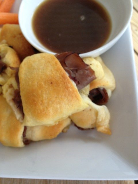 French Dip Crescents with easy Au Jus -- Easy, peasy and they taste like gooey deliciousness that can be made in no time. Deli roast beef, crescent rolls, and cheese make an impressive lunch if you need to impress, but also a quick, weeknight dinner. | thatwhichnourishes.com