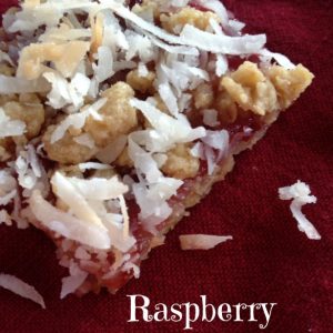 Raspberry Coconut Bars -- A shortbread-like crust containing oats and toasted coconut is blanketed with raspberries and more coconut to make a bar of yum that is unique and fruity. | thatwhichnourishes.com