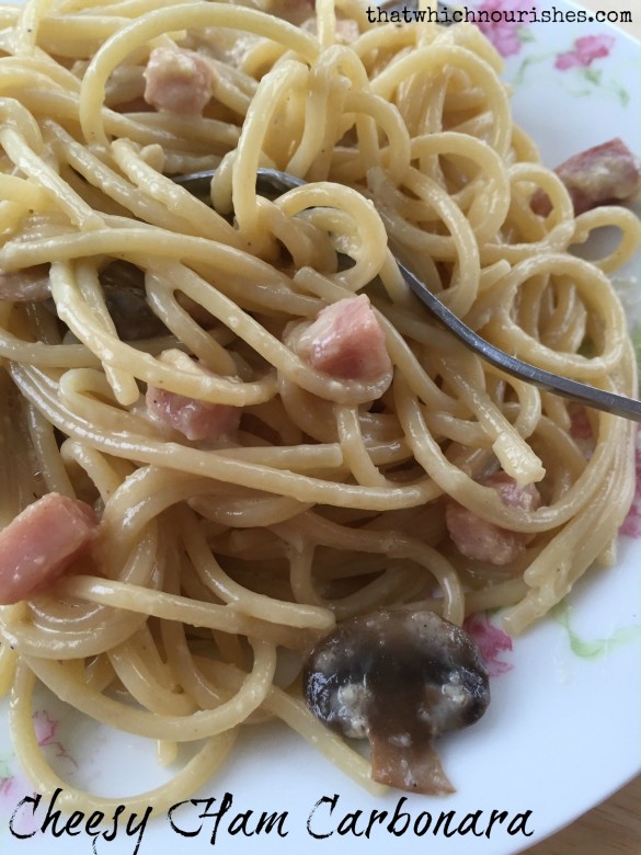Spaghetti noodles, ham, and mushrooms swim in a creamy garlic sauce made from cream and eggs and cheese. 