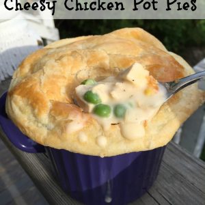 Cheesy Chicken Pot Pie -- Tender chunks of turkey or chicken and the veggies of your choice basking in a cheesy, rich and savory sauce, topped with buttery puff pastry and baked to pot pie perfection in less than an hour! | thatwhichnourishes.com