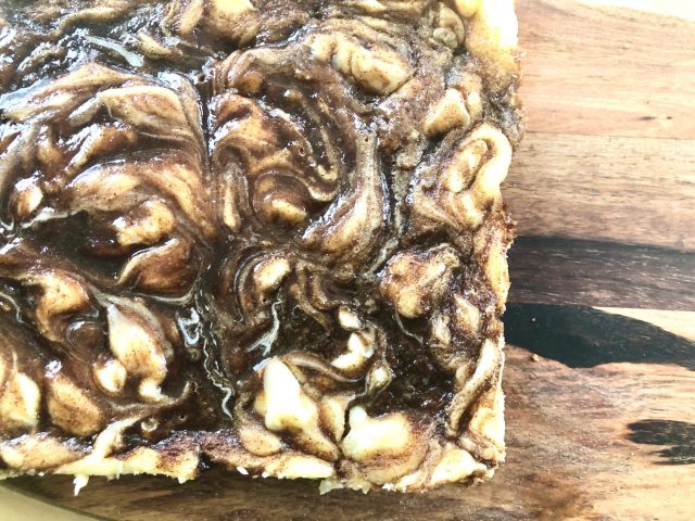 Cinnamon Roll Cheesecake Squares -- Goozy cinnamon roll filling draped and dripping from atop perfectly creamy little squares of cheesecake. These are all of the cinnamon-roll-love without the work! | thatwhichnourishes.com