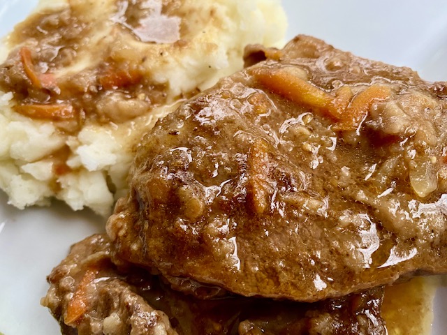 Savory Swiss Steak -- A savory sauce smothers tender pieces of beef slow cooked in a handful of savory pantry ingredients. This is how grandma made deliciousness from scratch out of a few simple, whole ingredients! | thatwhichnourishes.com