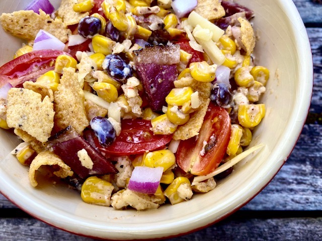 Southwest Corn Chip Salad -- Fresh and flavorful, this salad is bursting with southwestern veggies and seasonings making a unique and delicious salad with charred corn as the main ingredient and crunchy corn chips as the fun! | thatwhichnourishes.com