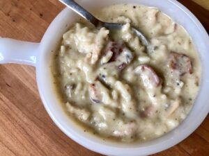Creamy Turkey and Wild Rice Soup -- the perfect way to use up leftover turkey or a rotisserie chicken. A thick, creamy, flavorful soup garnished with bacon | thatwhichnourishes.com