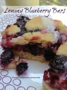 Lemony Blueberry Bars -- Rich, gooey, yummy blueberry filling ribboned into a moist, decadent cake and drizzled with a tart lemon glaze | thatwhichnourishes.com