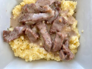 Savory Beef Stroganoff -- Tender strips of beef swimming in a rich and savory gravy and served over a bed of buttery noodles or polenta, this classic dish is simple, nourishing, and the essence of comfort food. | thatwhichnourishes.com