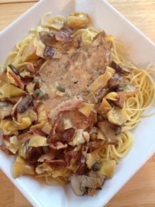 Chicken Scallopini -- Tender pieces of chicken, savory mushrooms, bacon, capers, and artichokes are nestled into pasta and bathed in a garlic, lemon, white wine cream sauce that you may just lick off of your plate. | thatwhichnourishes.com