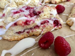 Glazed Raspberry Almond Scones -- soft, moist, buttery scones studded with fresh raspberries and blanketed in a sugary glaze | thatwhichnourishes.com