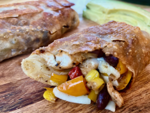 Southwestern Eggrolls with Bacon -- Southwestern veggies, seasoned chicken and beans, bacon and cheese all surrounded by a crispy egg roll wrapper fried in coconut oil. | thatwhichnourishes.com