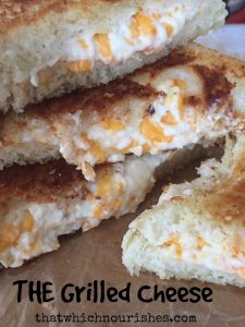 THE Grilled Cheese -- You'll just never eat one this good, I pretty much promise. Loaded with fresh garlic and a cheesy filling that's just too good to be true, I guarantee true love at first bite. | thatwhichnourishes.com
