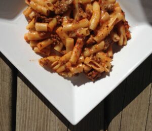 Cheesy Ziti -- Meat and pasta meet prepared red sauce, mozzarella, and seasonings and with a quick mix and bake you have gooey, cheesy yum. | thatwhichnourishes.com