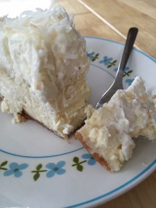 Creamy Coconut Cheesecake -- With a vanilla wafer and coconut crust, a layer of creamy coconut flavored cheesecake, and a coconut whipped cream topping, you are gonna be famous for this one. | thatwhichnourishes.com