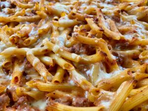 Ultimate Cheesy Pasta Bake -- Meat and pasta meet prepared red sauce, mozzarella, and seasonings and with a quick mix and bake you have gooey, cheesy yum. | thatwhichnourishes.com