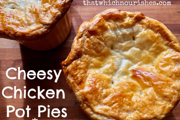 Cheesy Chicken Pot Pie -- Tender chunks of turkey or chicken and the veggies of your choice basking in a cheesy, rich and savory sauce, topped with buttery puff pastry and baked to pot pie perfection in less than an hour! | thatwhichnourishes.com