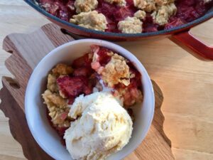 Strawberry Rhubarb Crisp -- Strawberries and rhubarb get married and make a delicious combination of sweet and tart under a crispy blanket of buttery oats and brown sugar. | thatwhichnourishes.com