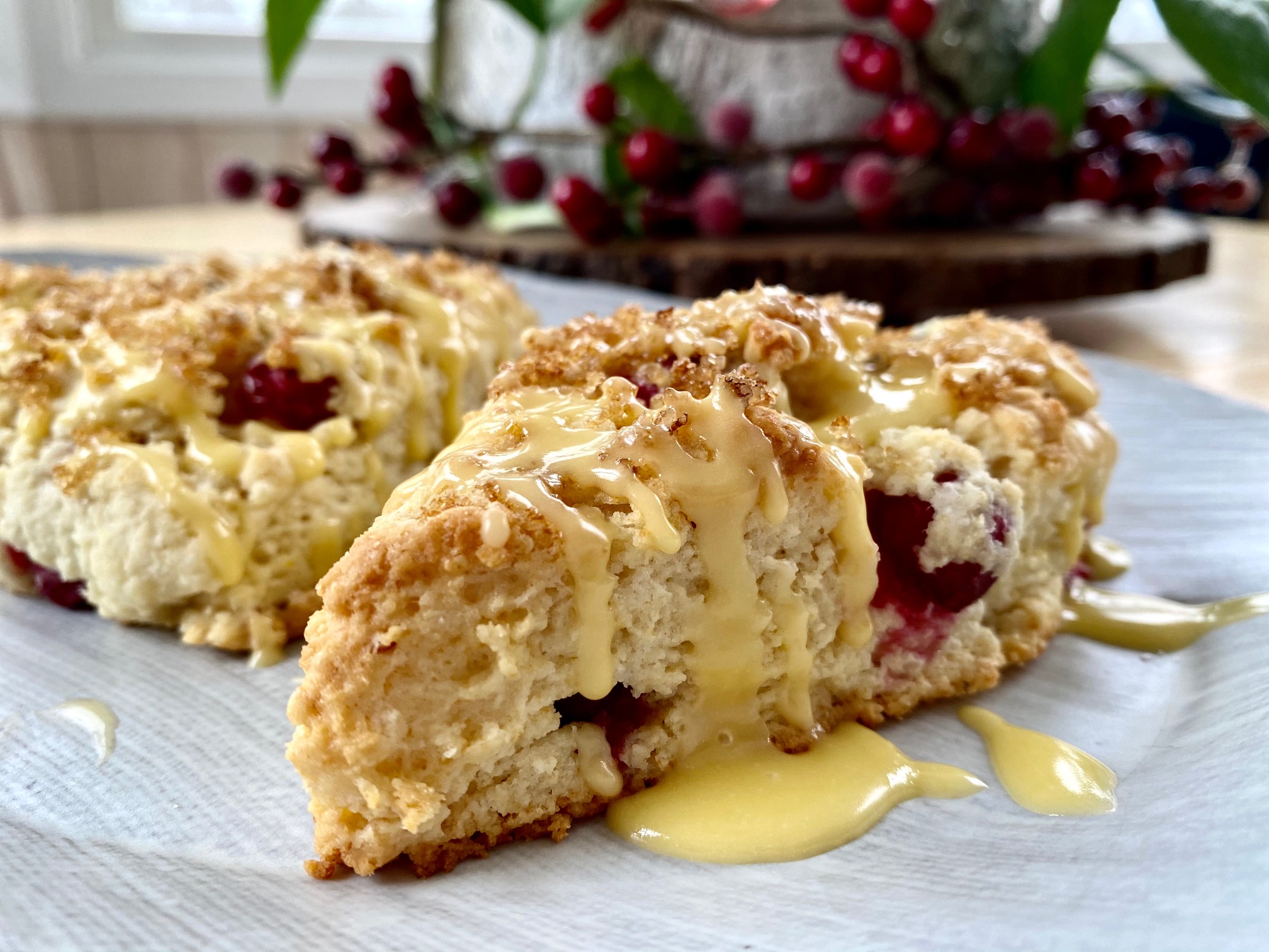 Bright pops of tart cranberries stud a soft and flaky, slightly sweet, melt-in-your-mouth scone with a hint of orange topped with orange sugar and a tart orange glaze. |thatwhichnourishes.com