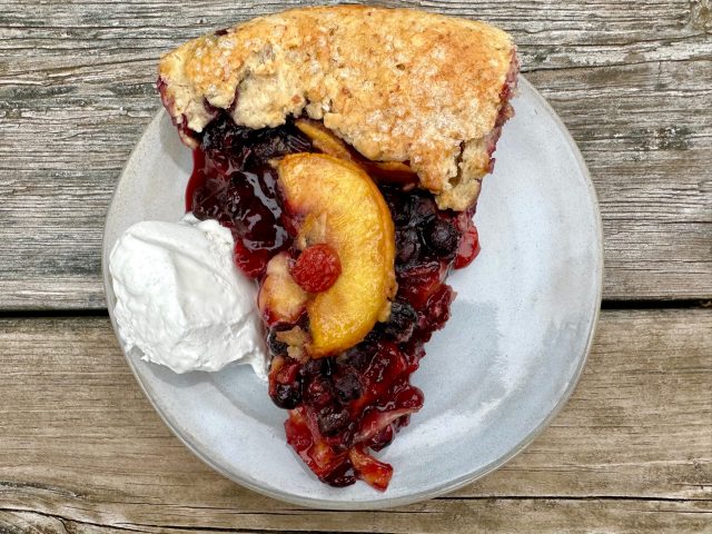 Summer Fruit Pie -- Edible gold in the form of all the juicy summer fruits fill a gorgeous, rustic crust made in a cast iron skillet. Bubbling hot filling in a crunchy almond crust make a pie you'll absolutely drool over. | thatwhichnourishes.com